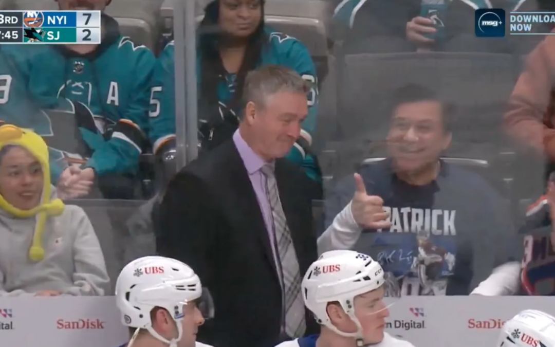 Roy tosses puck to fan wearing his shirt behind bench